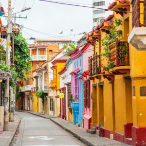 a narrow city street lined with colorful buildings