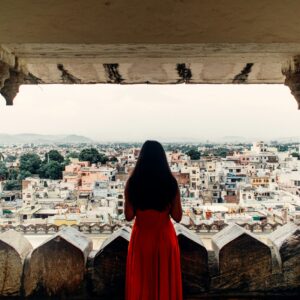 person in red hoodie standing on top of building during daytime